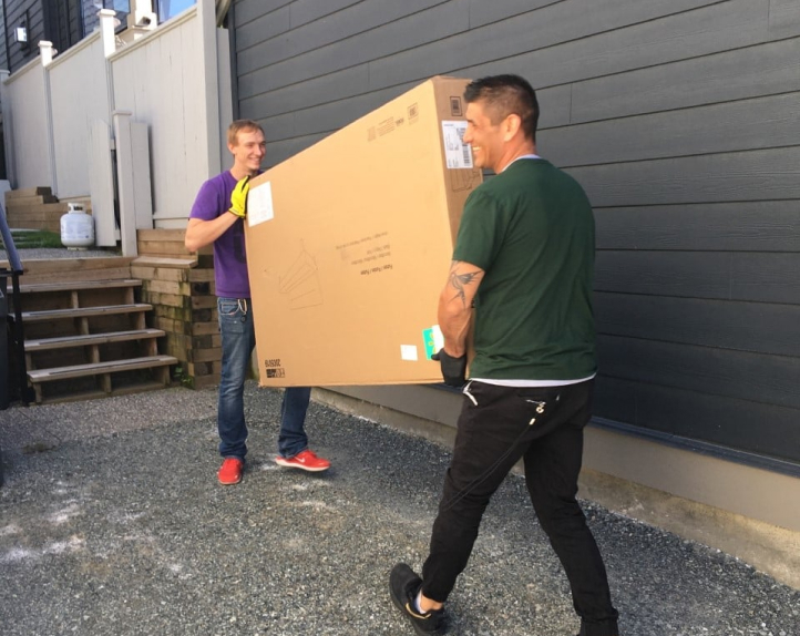 two men carrying box